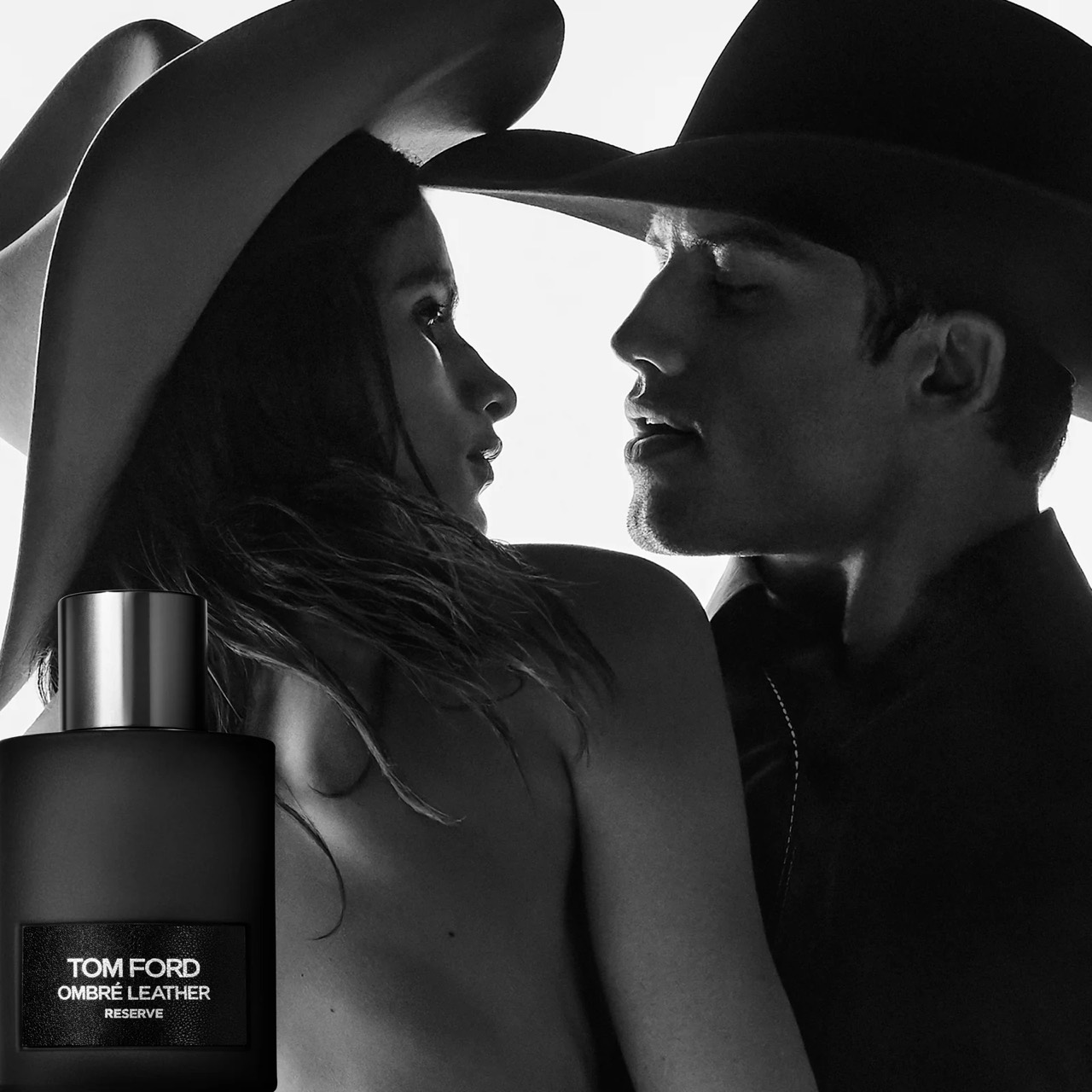 Tom Ford Ombré Leather Reserve campaign image with two models in cowboy hats and the Reserve bottle